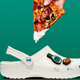 Graphic of pizza dripping ranch onto white Croc with ranch charms